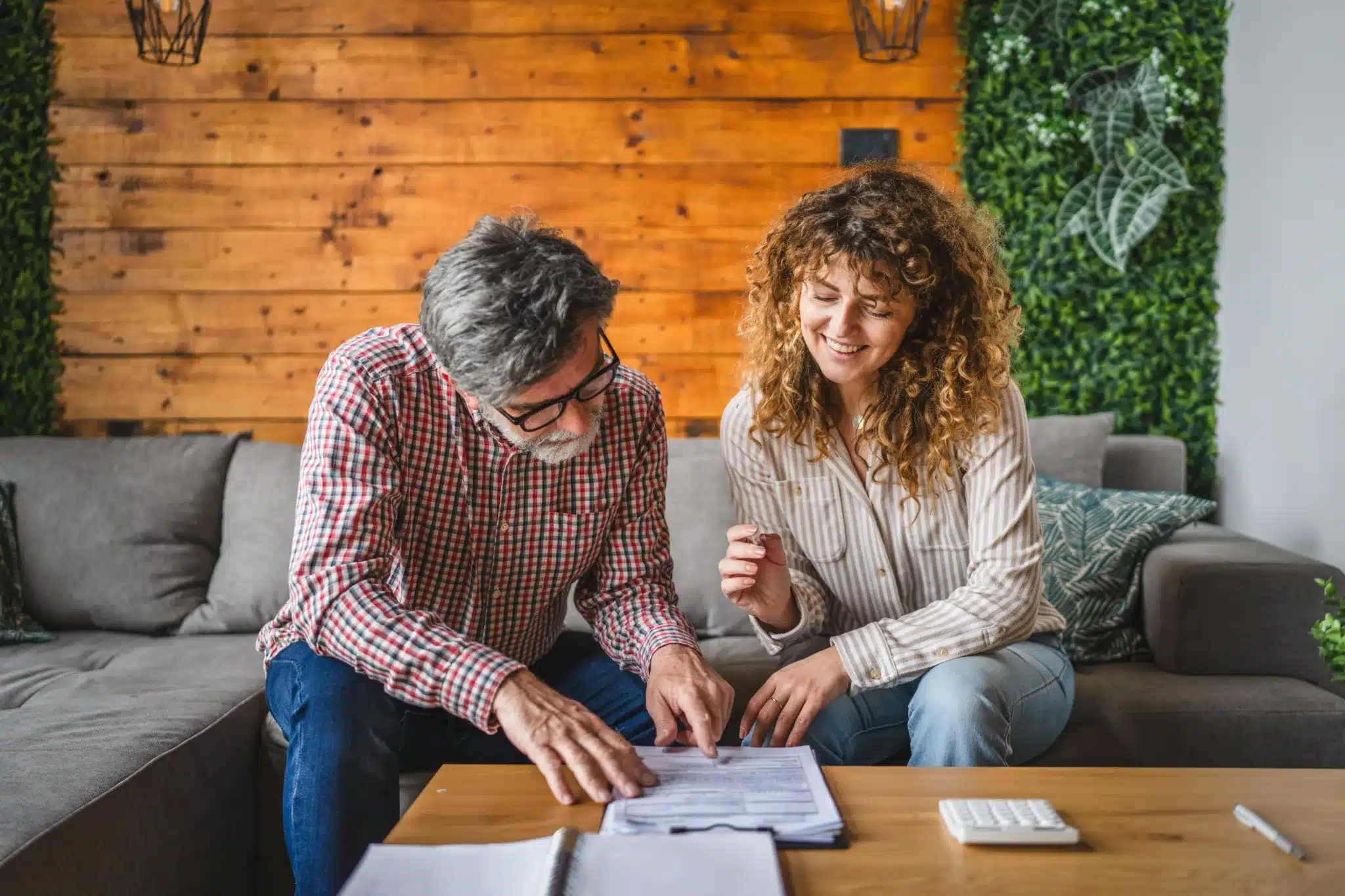 Two people reviewing documents together at home.